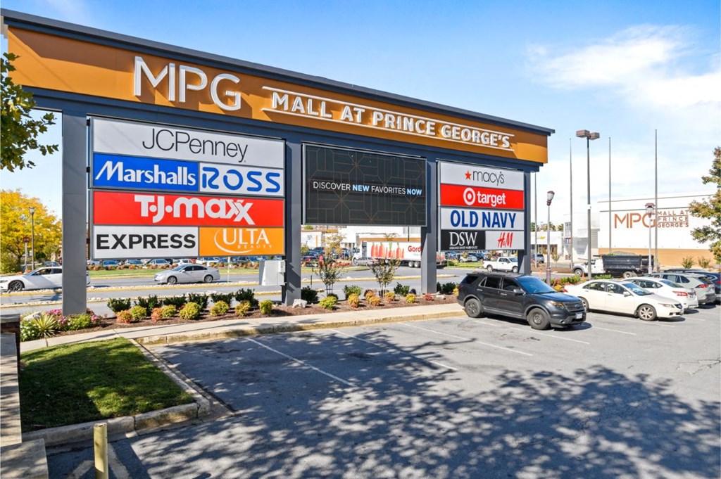 a shopping mall at prince with cars in the parking lot