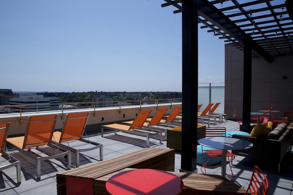 a row of orange chairs on top of a roof