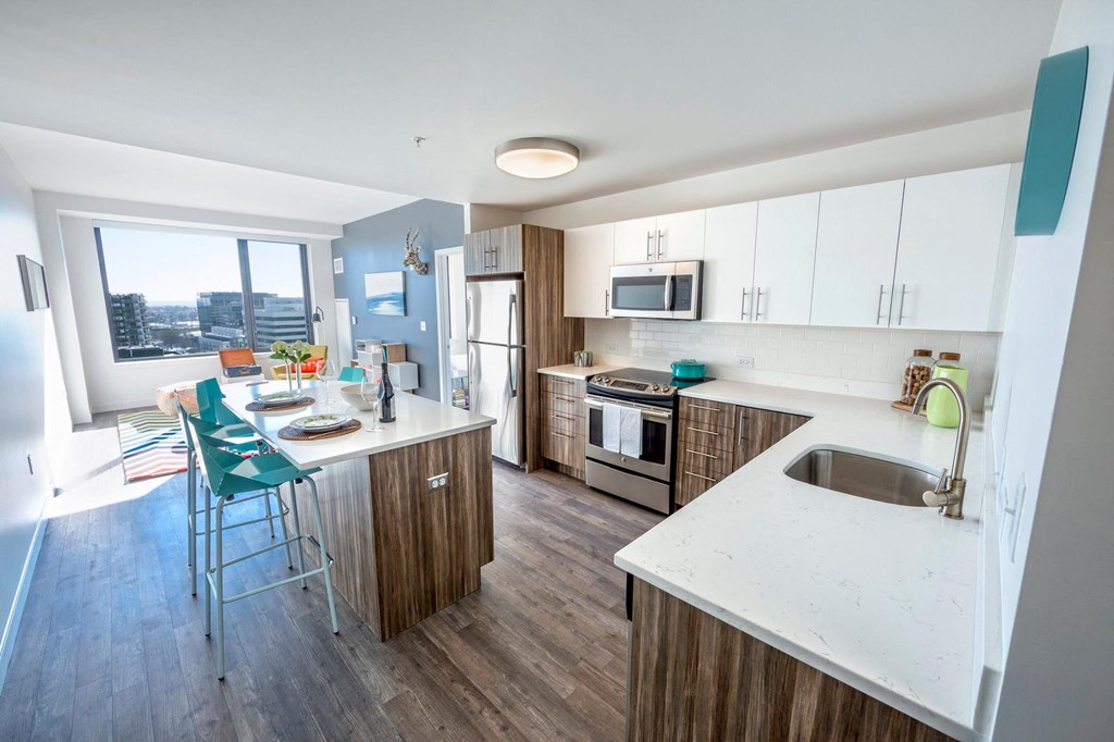 a kitchen with an island and a table with chairs