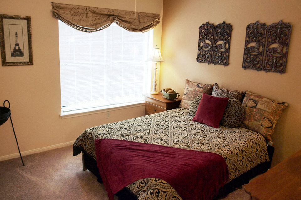 a bedroom with a bed and a window