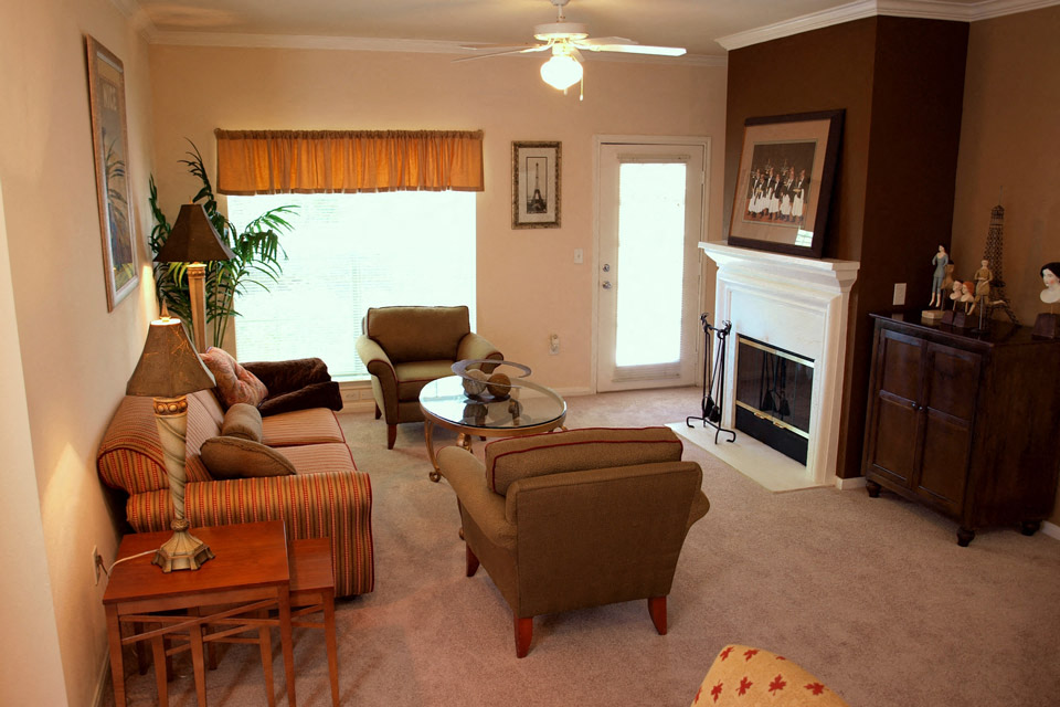 a living room with couches and chairs and a fireplace