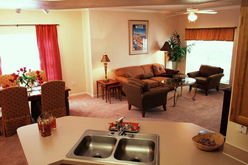 a living room with a couch and a table and a sink