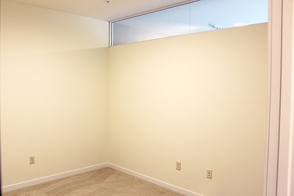 an empty room with a mirror on the wall