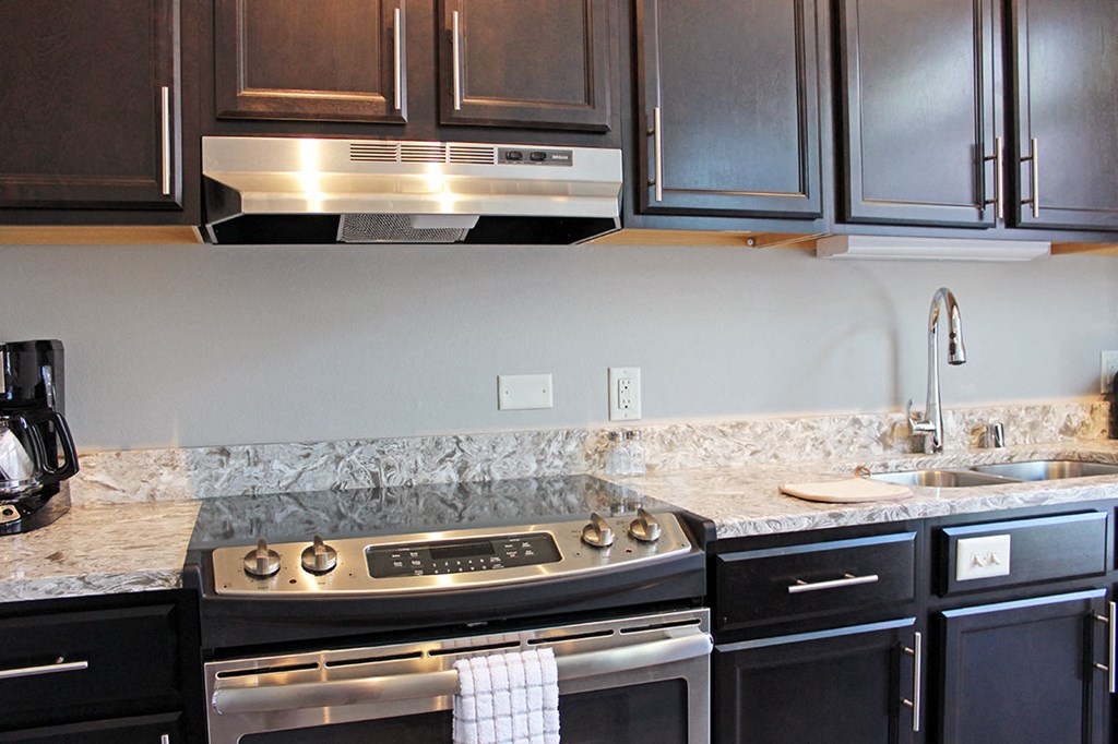 a kitchen with black appliances and granite counter tops