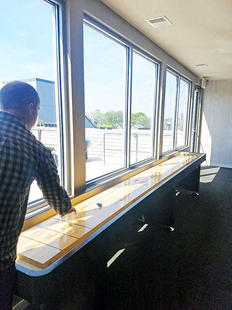a man is looking out a window at a table