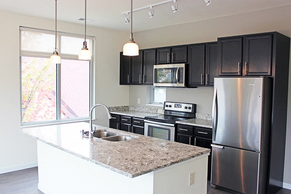 a kitchen with stainless steel appliances and granite counter tops