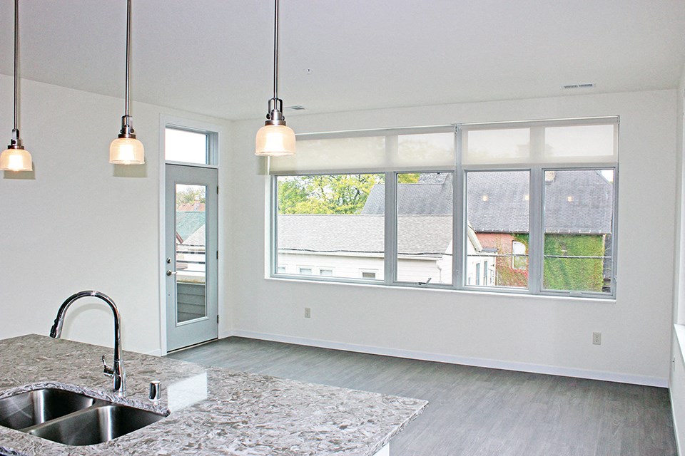 an empty kitchen with a sink and a window