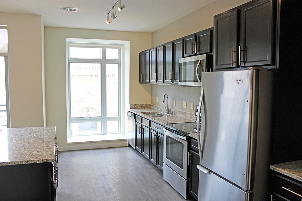 a kitchen with stainless steel appliances and black cabinets