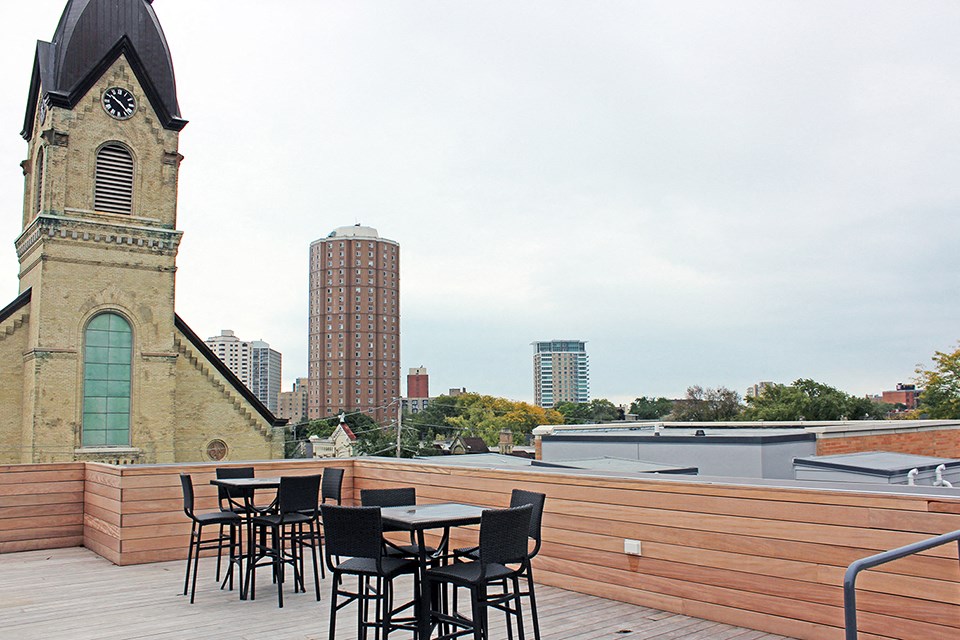 a roof top restaurant with a view of the city