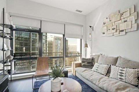 a living room with a large window and a couch