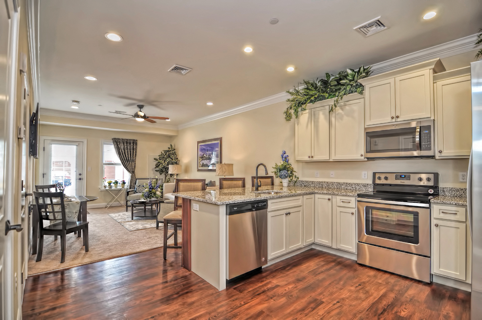A kitchen with a stainless steel dishwasher and oven.