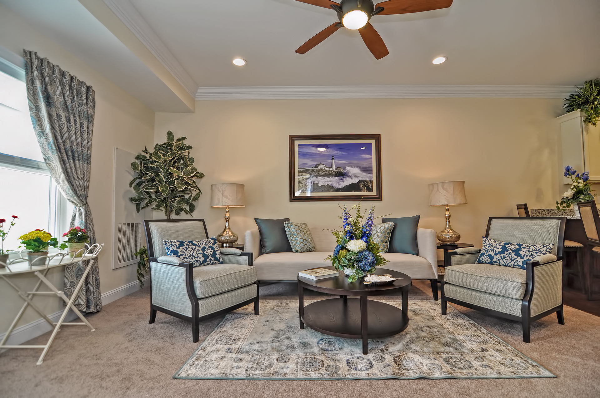 A living room with a couch, chairs, and a painting on the wall.