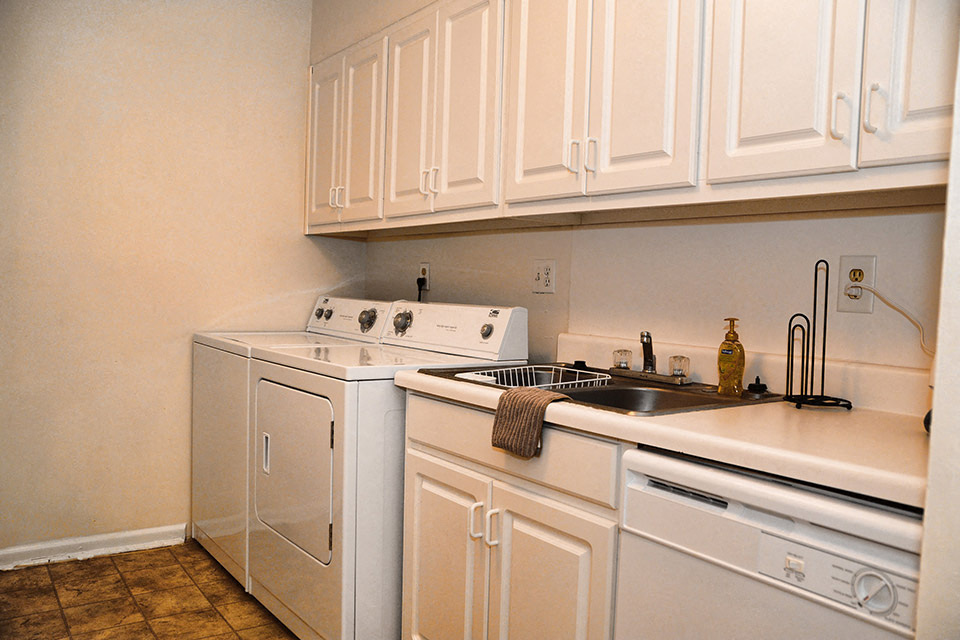 a kitchen with white appliances and white cabinets