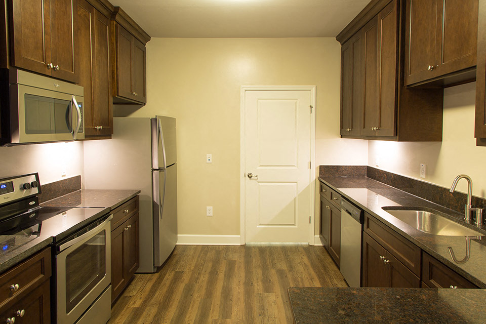 kitchen with stainless appliances and dark cabinets