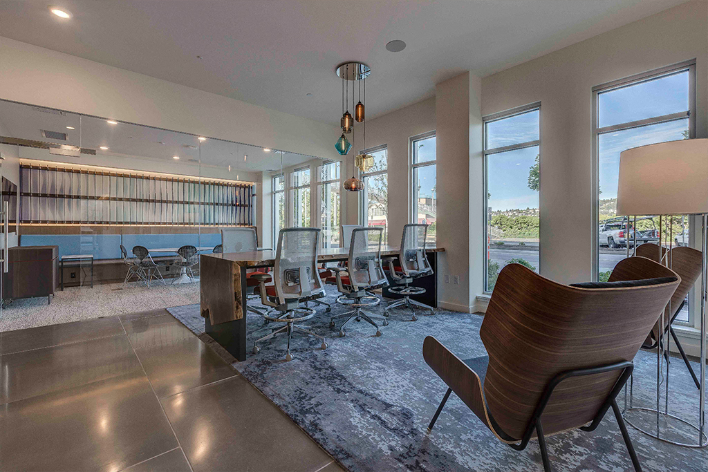 a conference room with large windows and a table and chairs