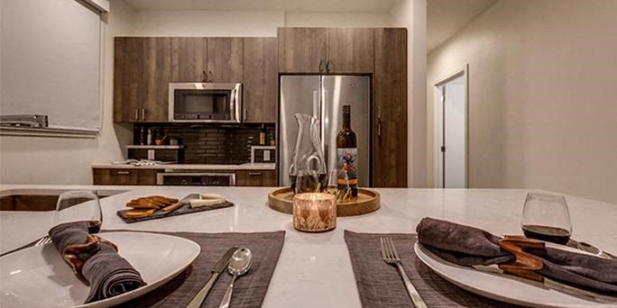 a kitchen with a table and a refrigerator