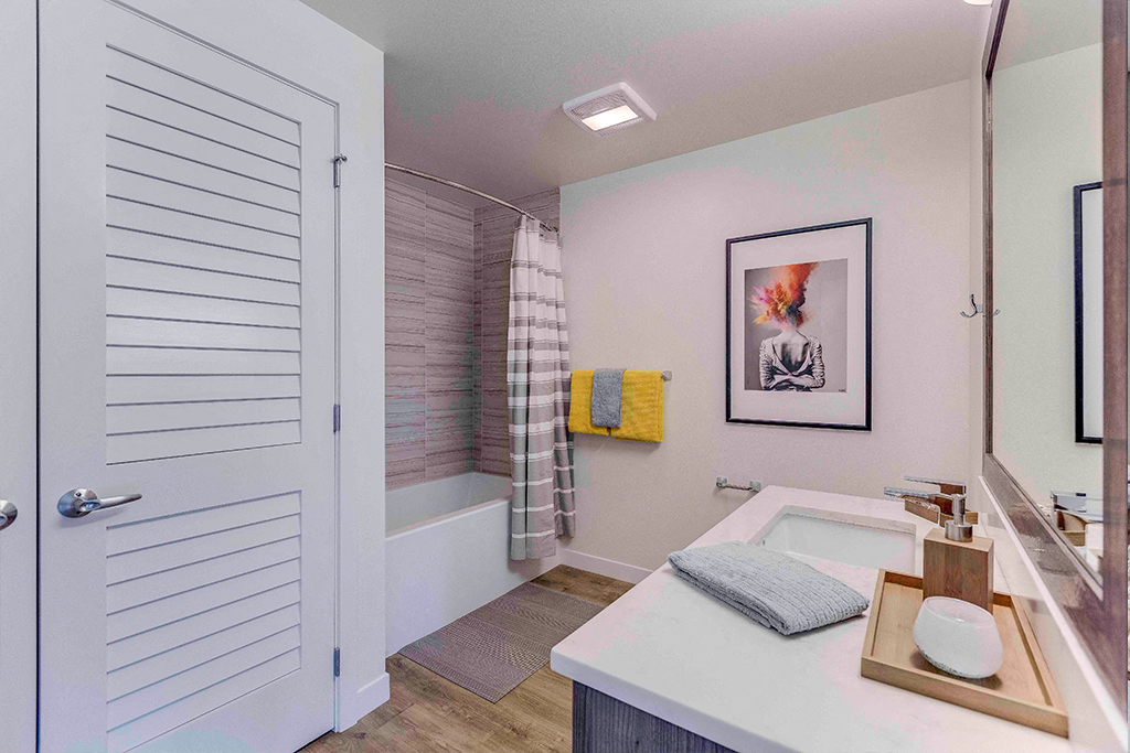 a bathroom with a tub and a shower and a sink