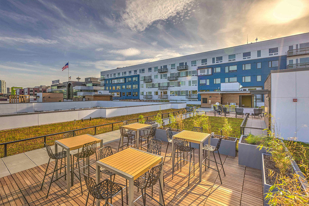 a terrace with tables and chairs on a roof