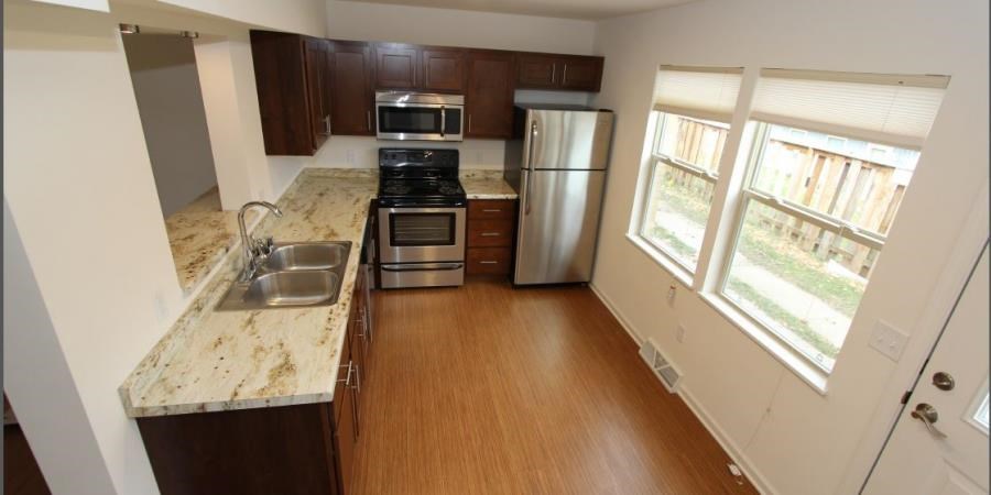 a kitchen with stainless steel appliances and marble counter tops