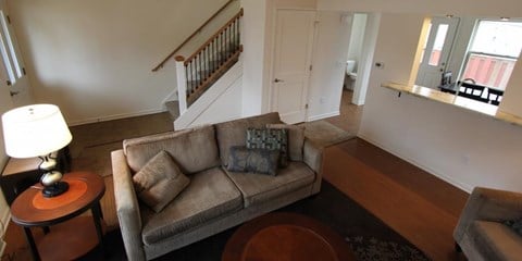 a living room with a couch and a staircase