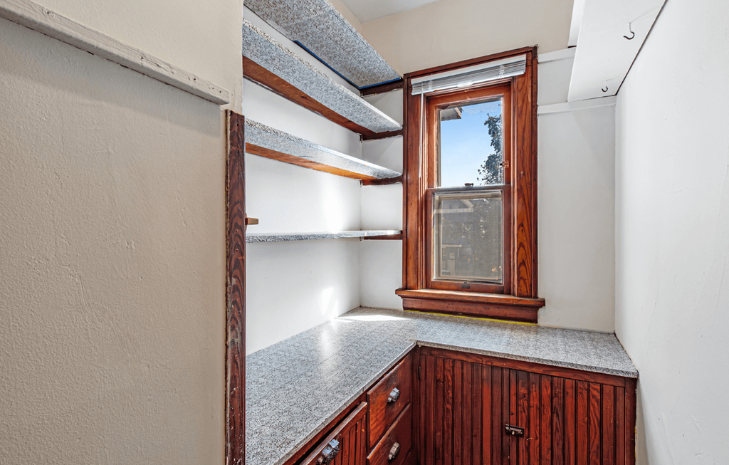A kitchen with a window and a counter.
