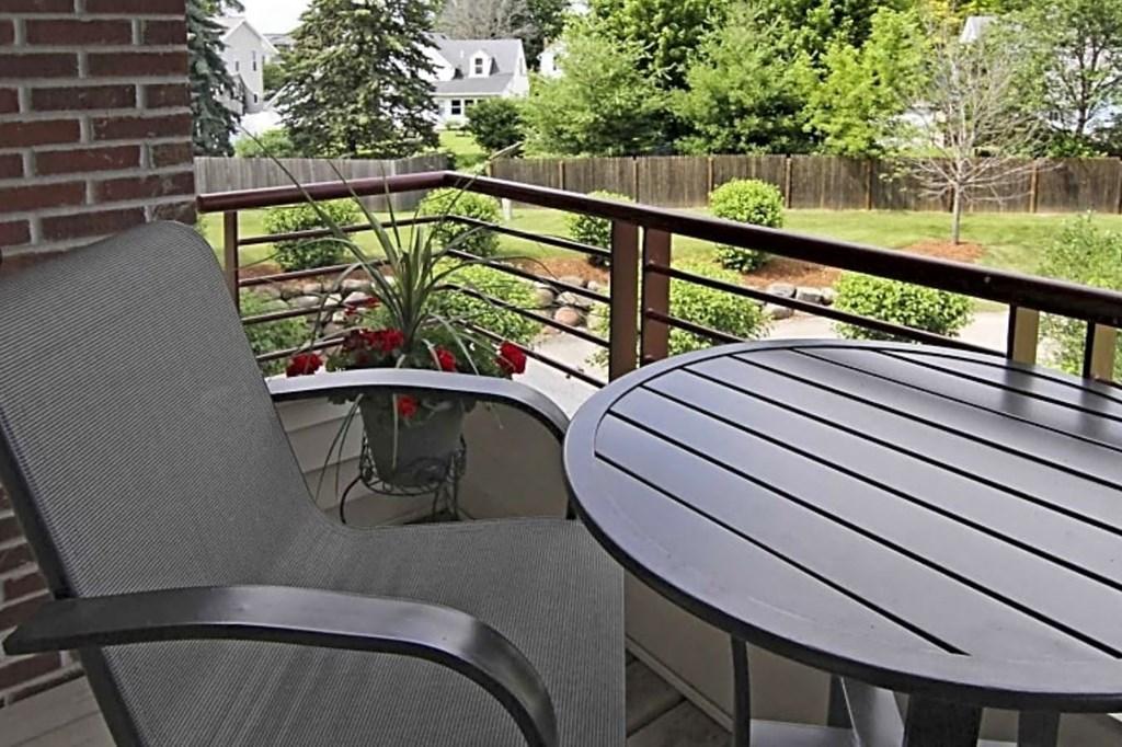 a patio with a table and chairs on a balcony