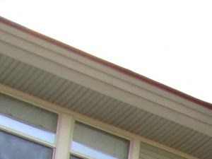 the front of a brick apartment building with white flowers