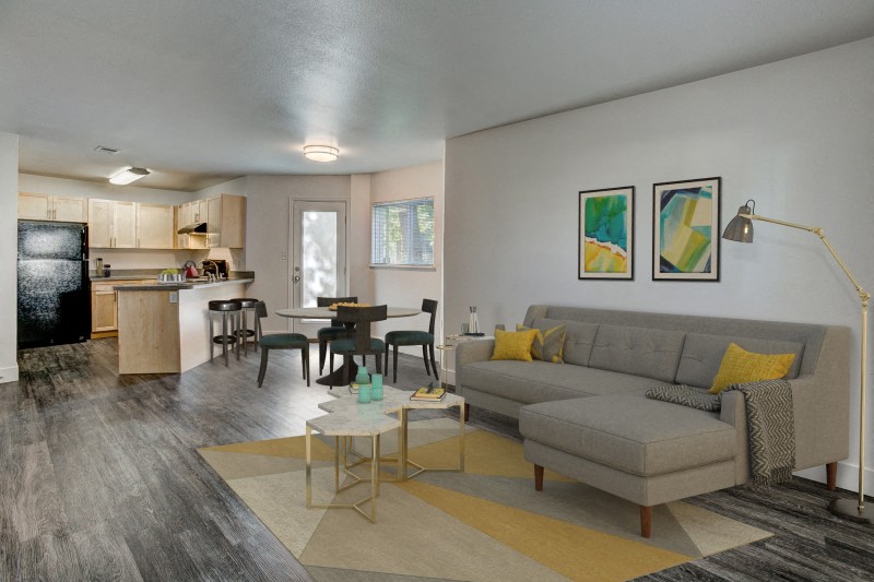a living room and kitchen with a couch and a table
