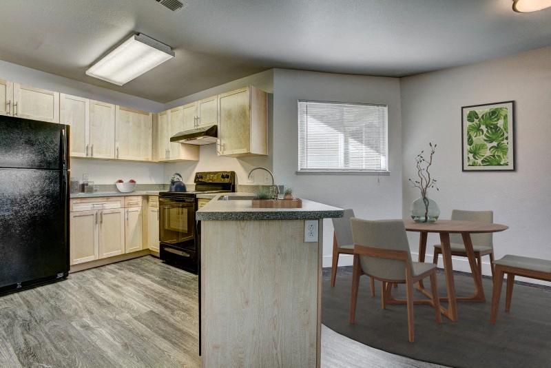 a kitchen with an island and a table with chairs