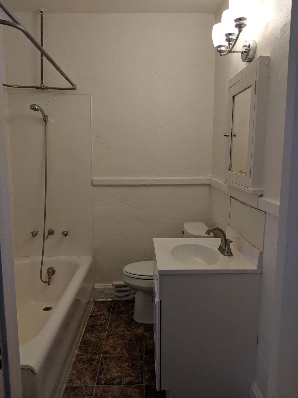 a small bathroom with a sink toilet and shower