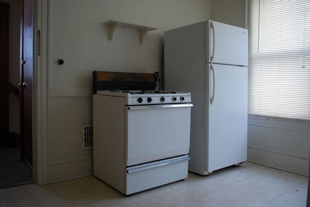 a kitchen with a stove and a refrigerator