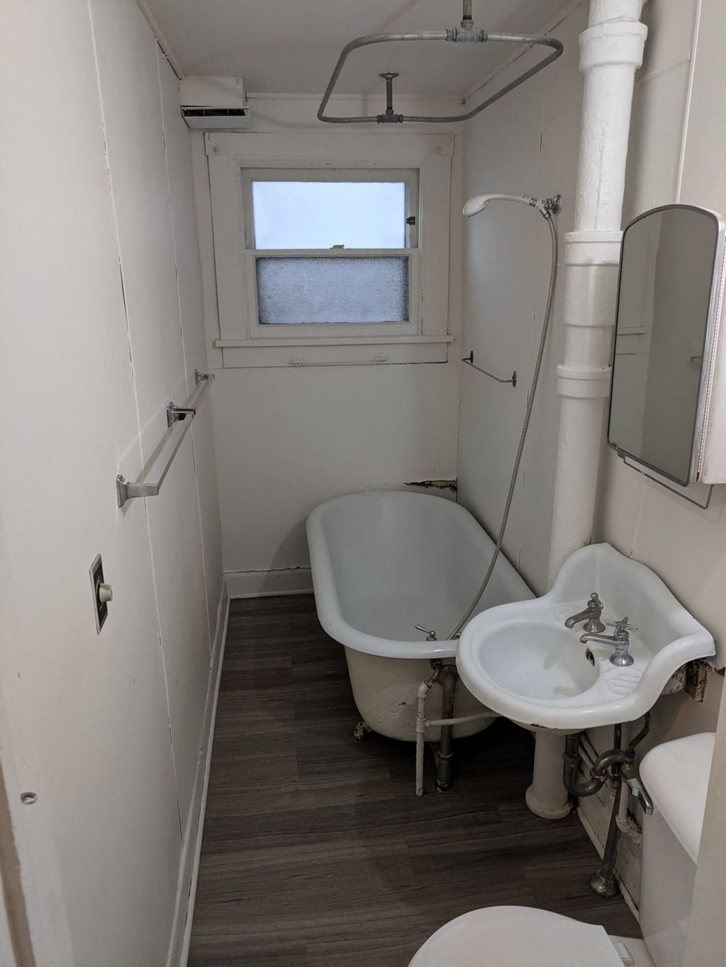 a small bathroom with a sink and a bath tub