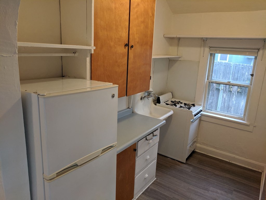 a small kitchen with a stove and a refrigerator