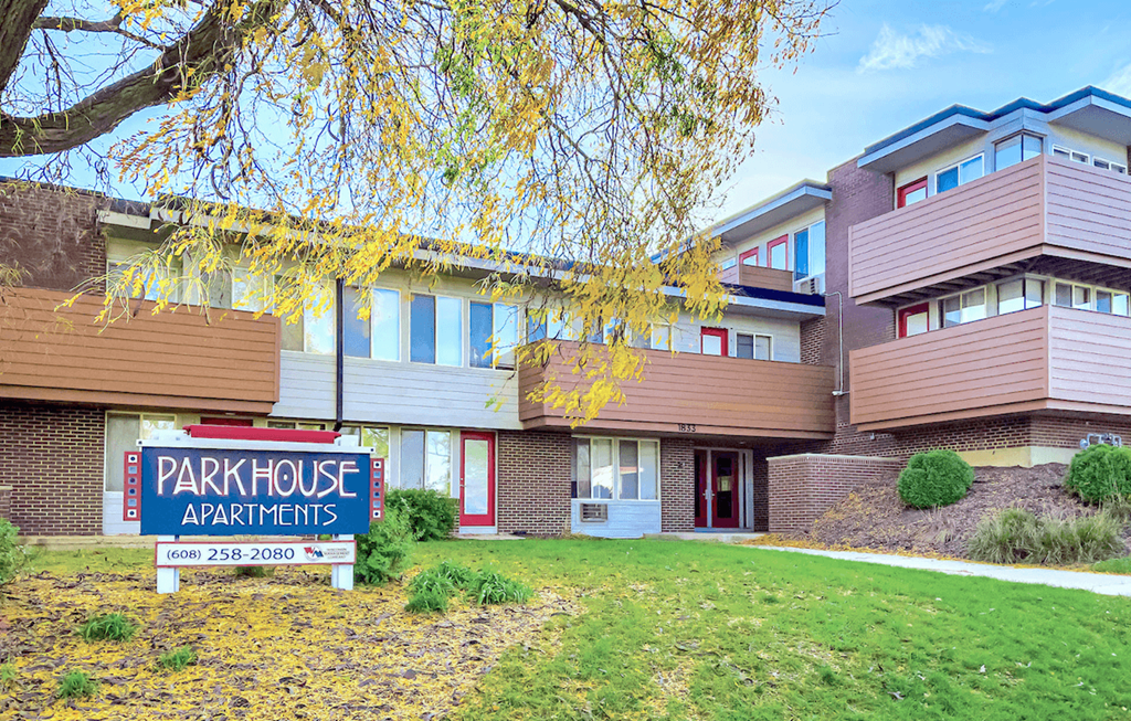a park house apartments sign in front of a building