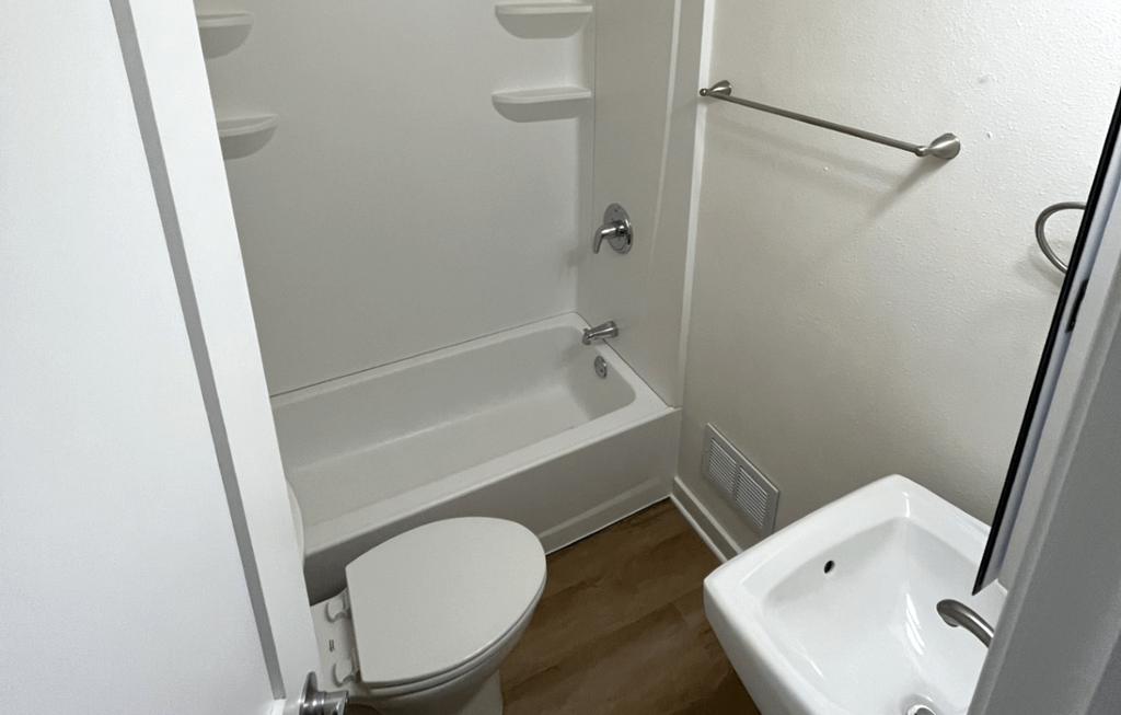 a small bathroom with a toilet and a bath tub