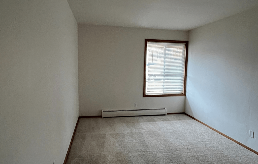the living room of an empty house with a window