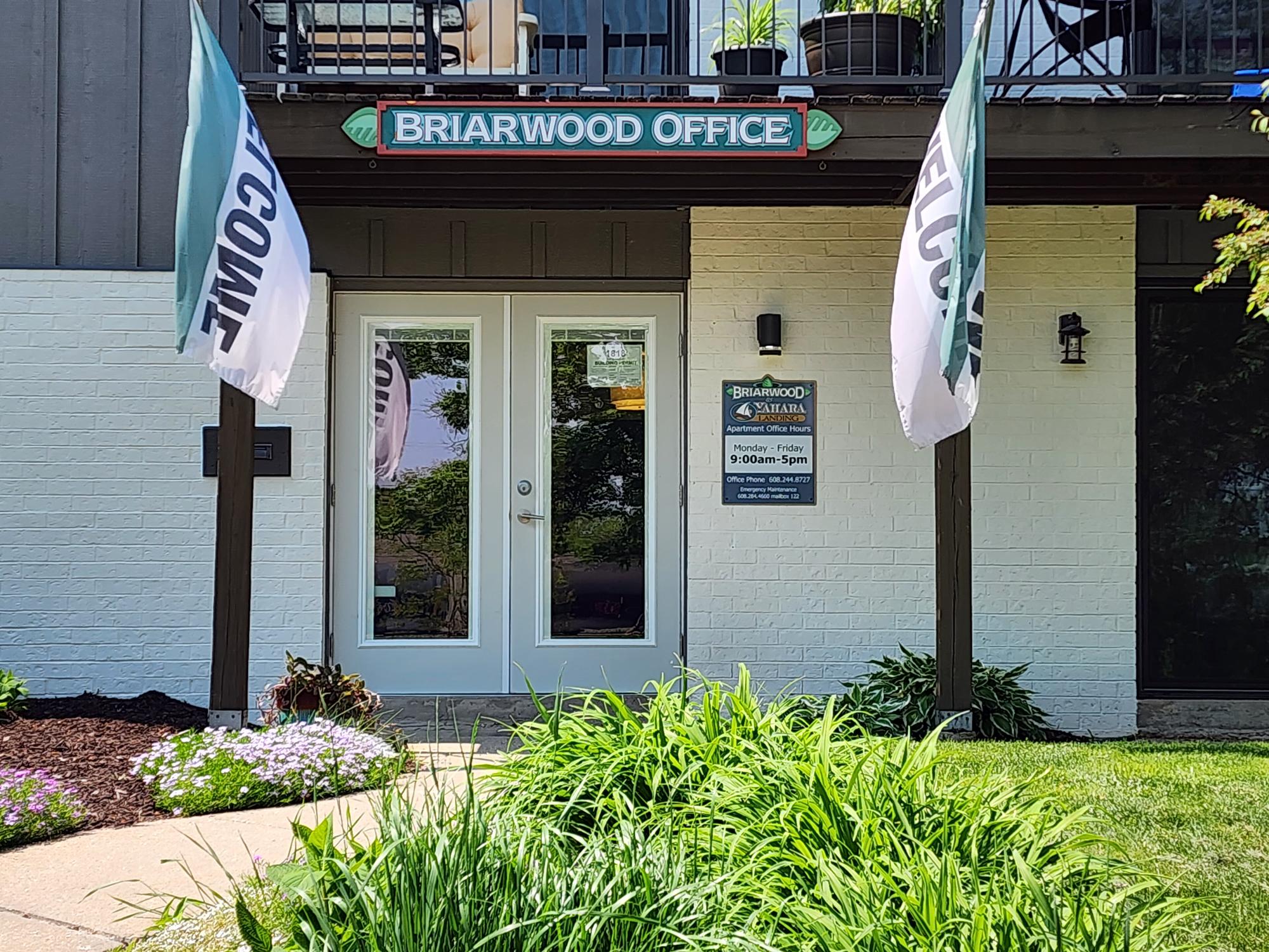 the front of the brahranwood office building with flags