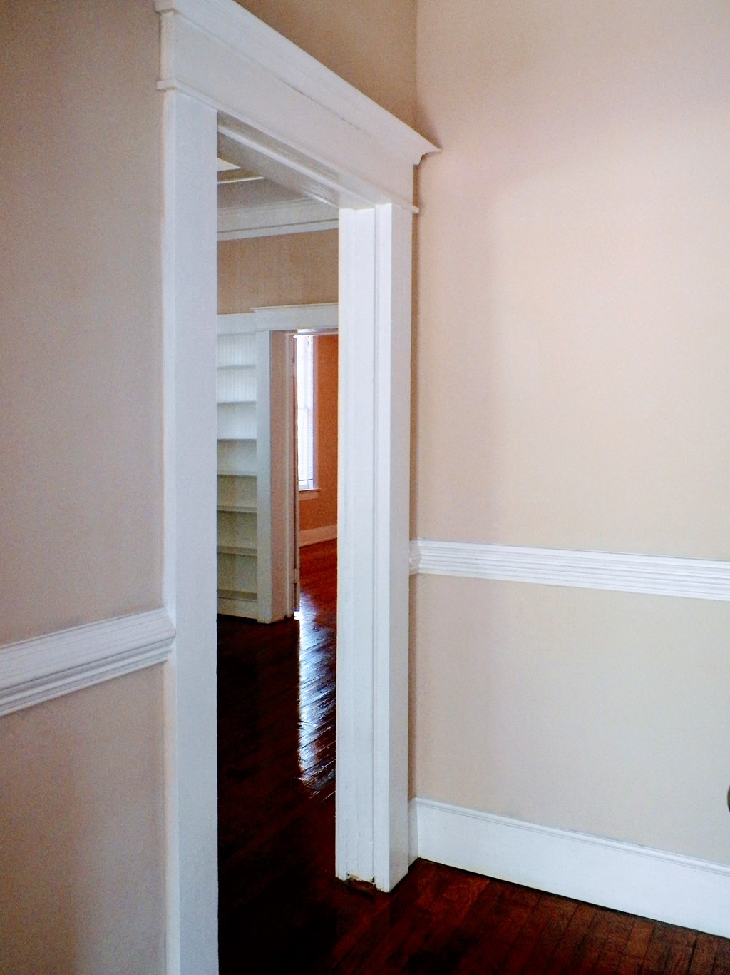 the doorway to the office is open to the hallway and the living room