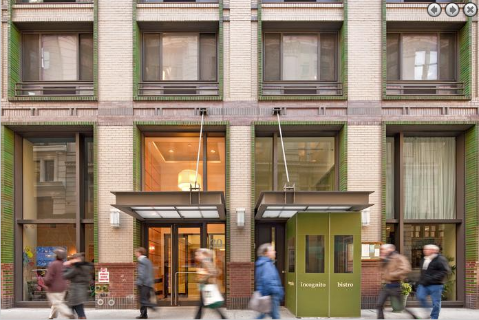 a group of people walking in front of a building