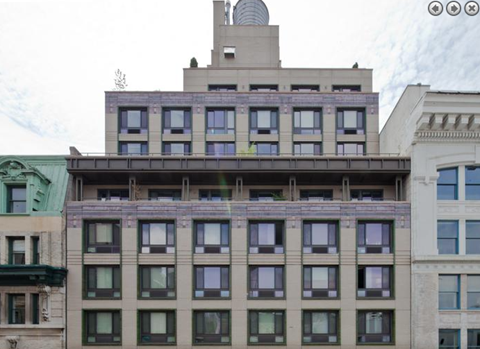 a building with many windows and a antenna on top of it