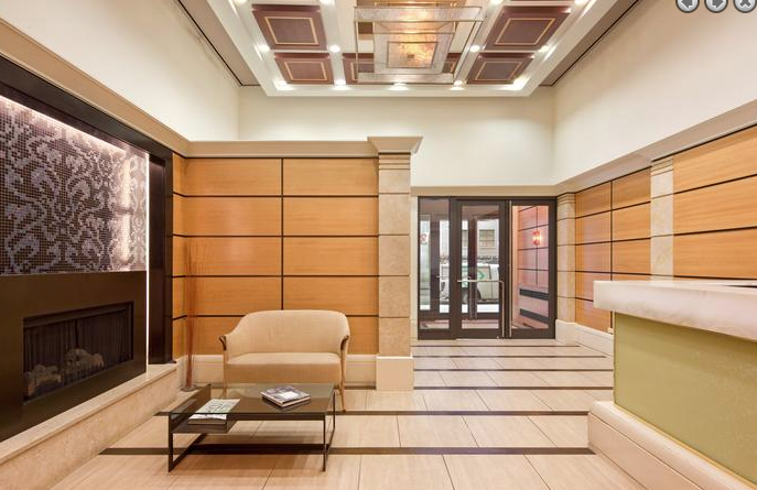 a lobby with a fireplace and a chair and a table