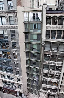the facade of a tall building with balconies on it