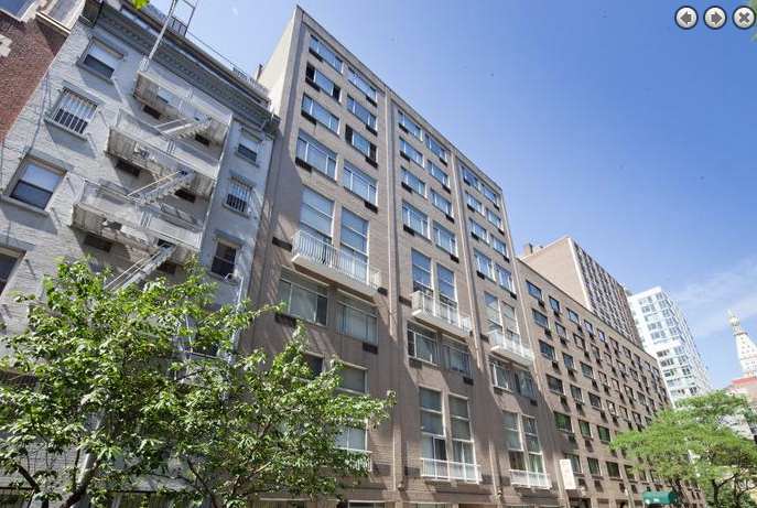 a tall building with a tree in front of it