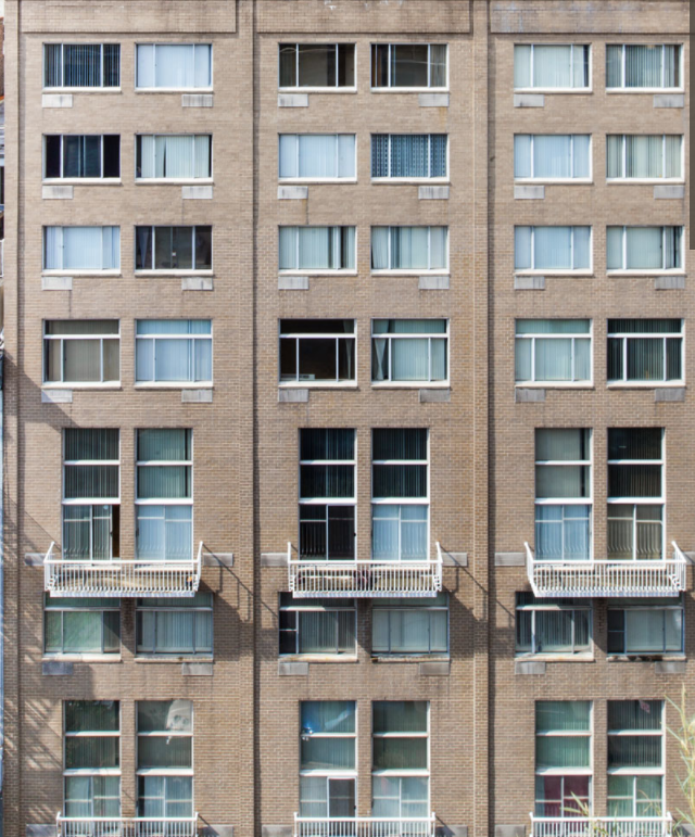 the facade of an apartment building with windows and balconies