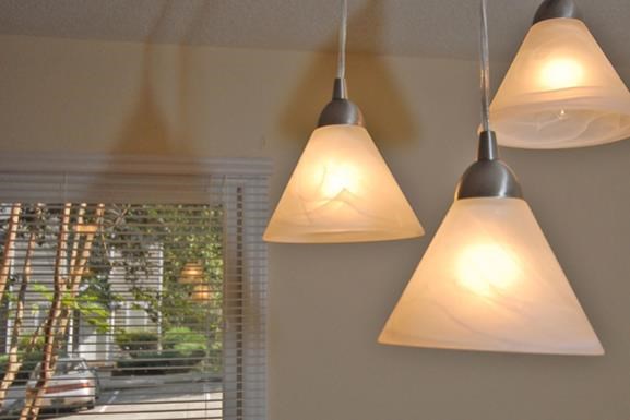 three lamps hanging from a wall next to a window