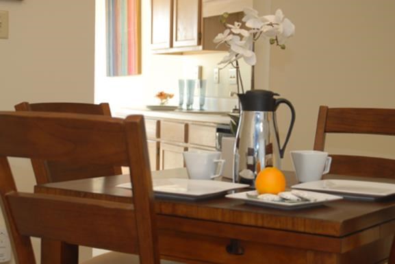 a table with two chairs and an orange on it