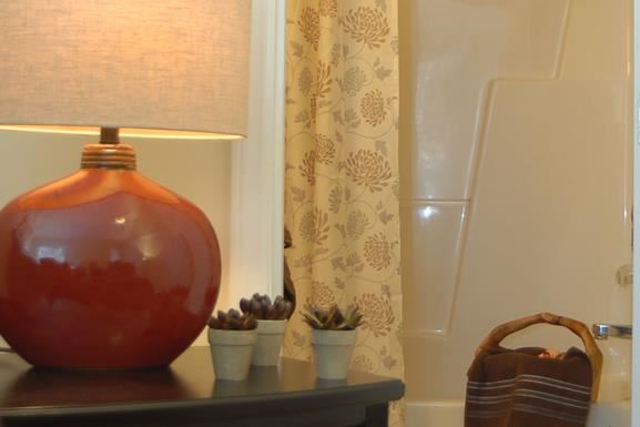 a red vase sitting on top of a table