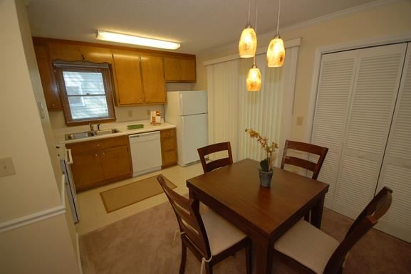 a kitchen and dining room with a table and chairs