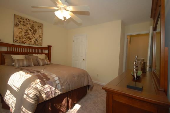 a bedroom with a bed and a ceiling fan