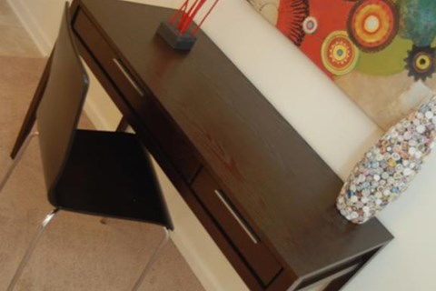 a wooden desk with a chair next to it